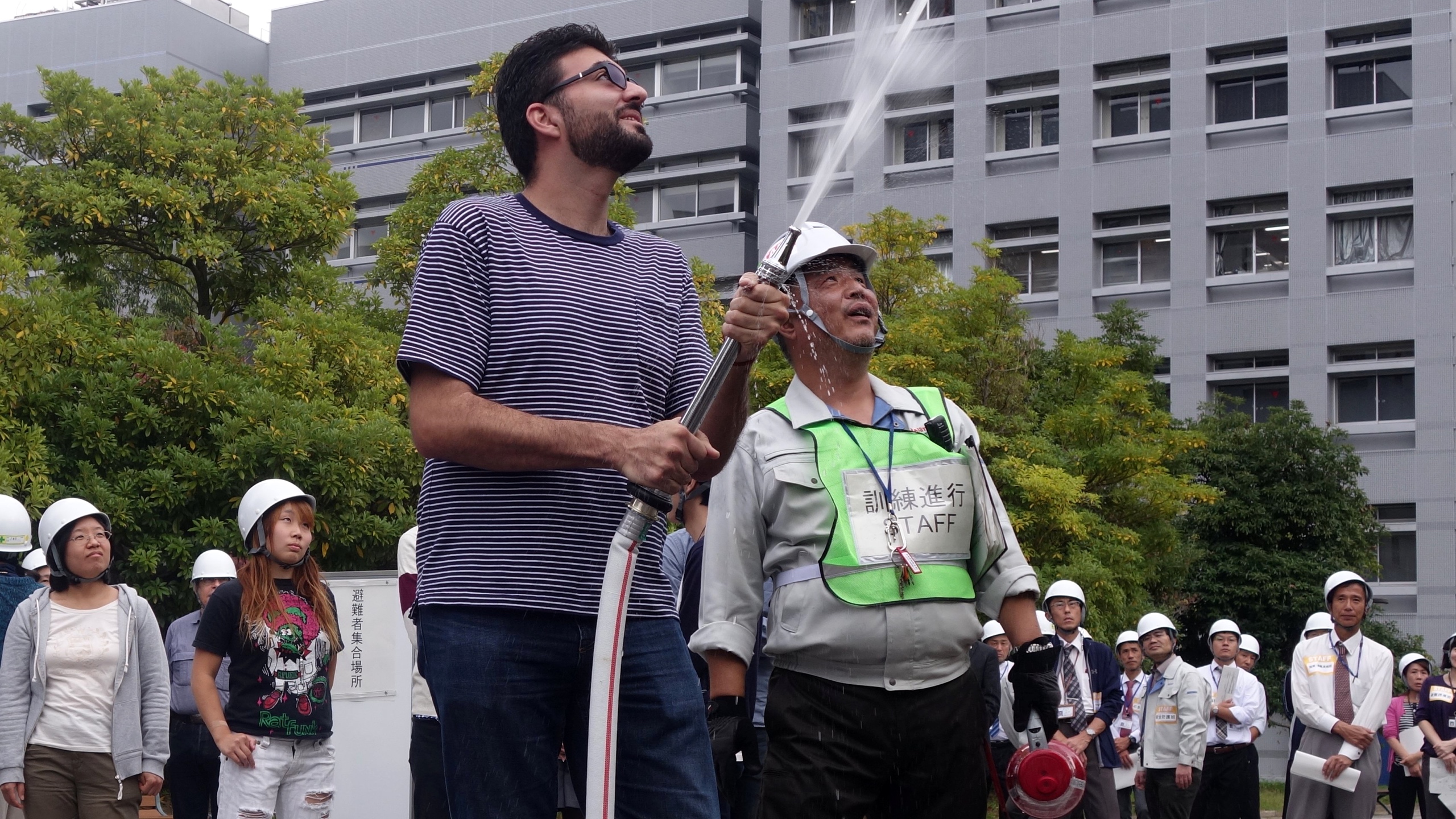 NAIST student Rodrigo Elizalde trying out a water hose.